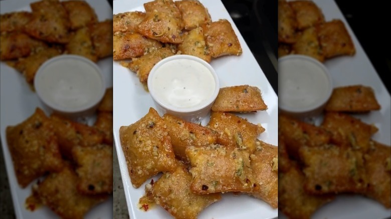 Garlic parm pizza rolls on plate with dip
