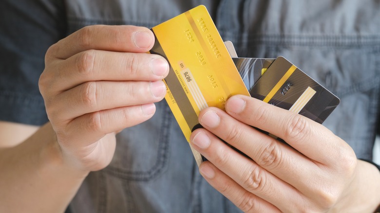 man holding credit or gift cards