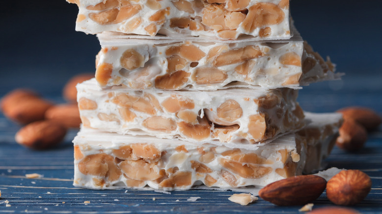 Stack of turrón with almond pile