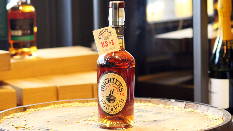 A bottle of Michter's bourbon on a barrel