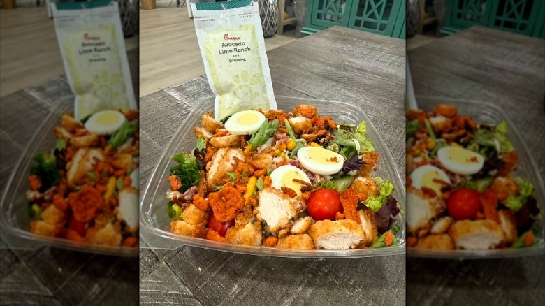 Cobb Salad from Chick-fil-A in a takeout box with a packet of Avocado Lime Ranch on a table