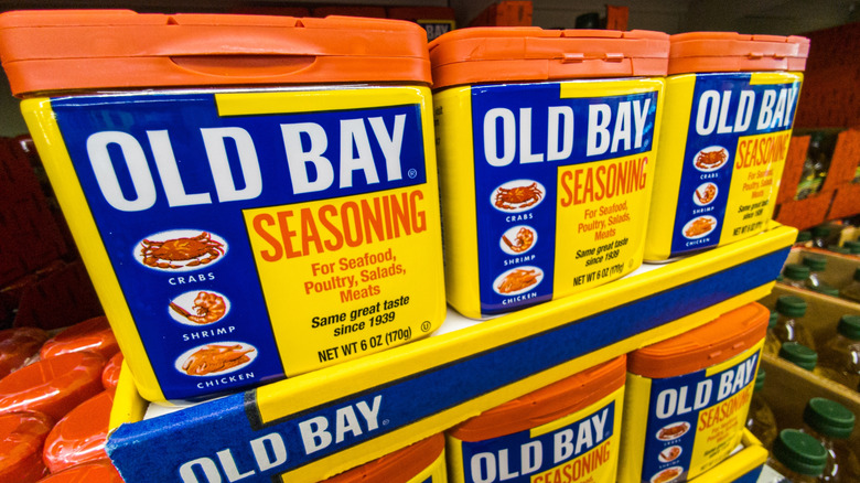 Several cannisters of Old Bay Seasoning lined up together on a store shelf