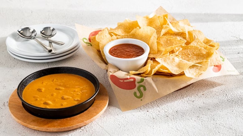 Beef Queso next to bowl of chips