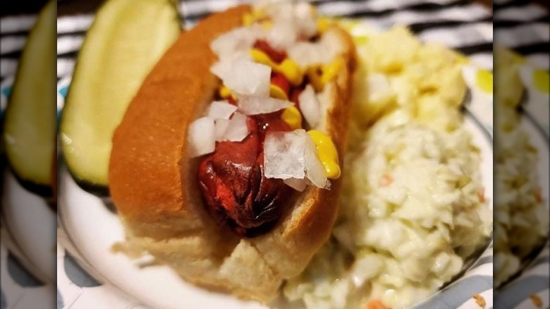 bright leaf hot dog topped with onions 