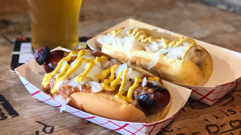 white hot dogs with toppings and beer
