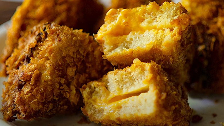 Cheese frenchees, with one sliced in half to show the filling