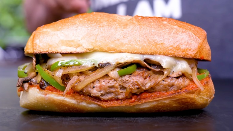 Cudighi sandwich with sliced onions and peppers, with melted cheese