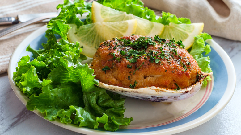 Stuffed clam served on a half shell, with lettuce