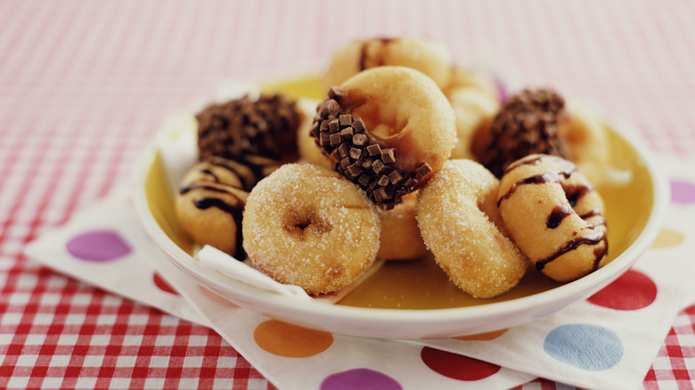 Donuts on white plate with colorful napkins