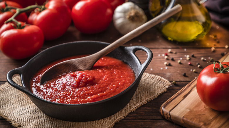 Tomato sauce with wooden spoon