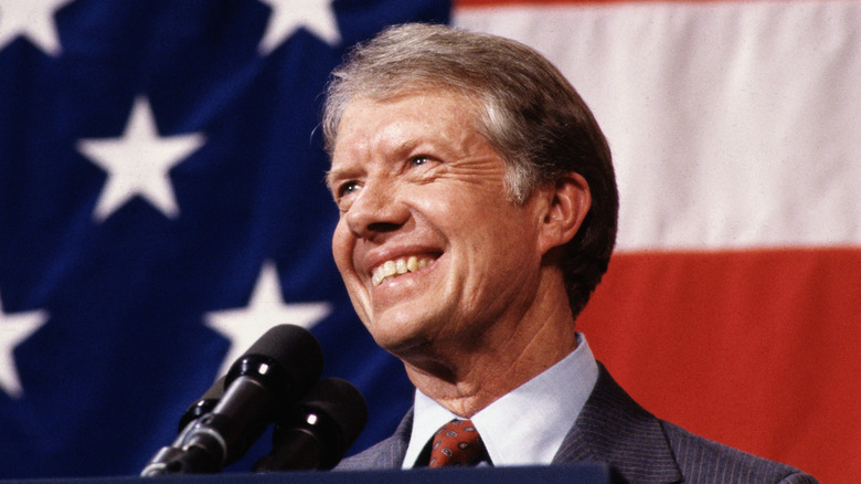 Jimmy Carter at a podium in front of a US flag