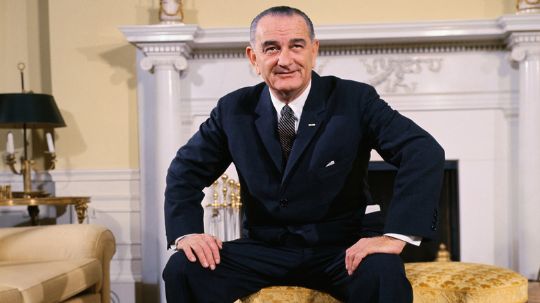 LBJ seated in front of the Oval Office fireplace