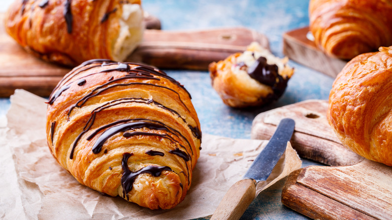 three chocolate croissants on paper