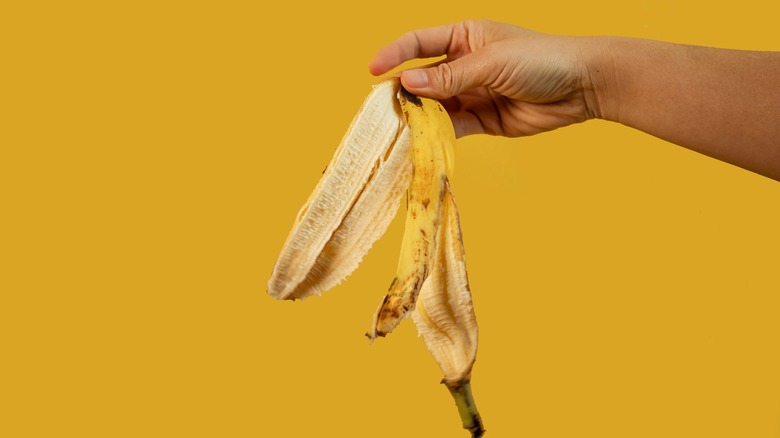 Hand holding banana peels