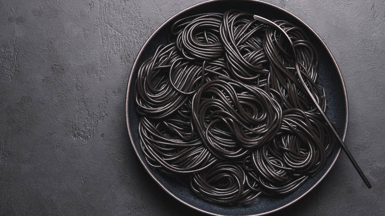 squid ink pasta on black plate
