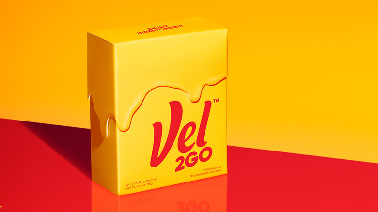 a box of Velveeta's new Vel2go product on a bold yellow and red backdrop