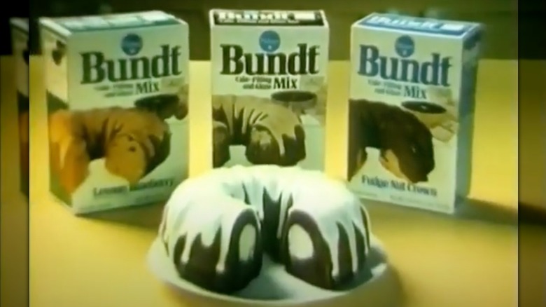A selection of Pillsbury Bundt Cake mixes, with a cooked bundt cake, shown in a vintage TV commercial