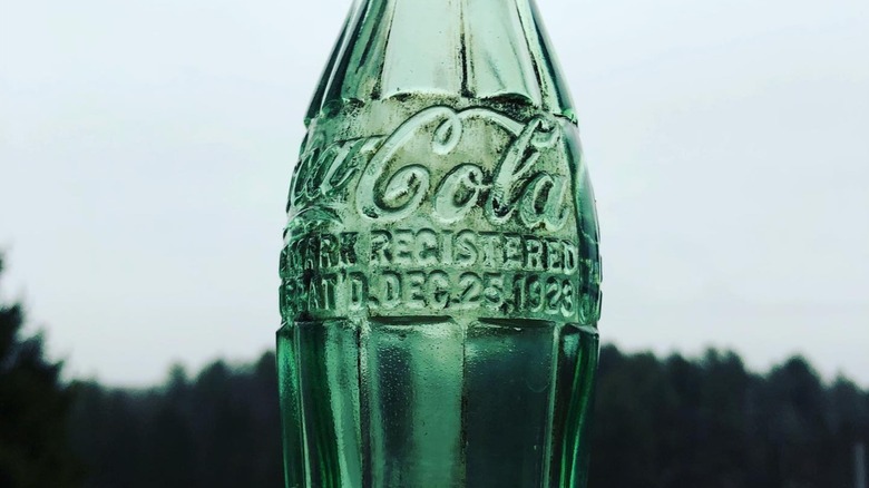 Close-up of a Coca-Cola bottle marked 1923