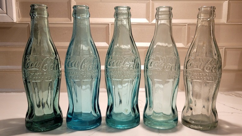A row of Coca-Cola 1915 hobbleskirt bottles