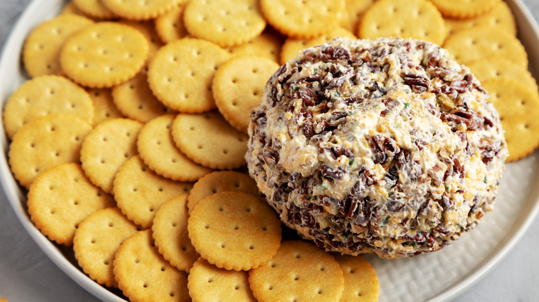 A large cheese ball and Ritz crackers