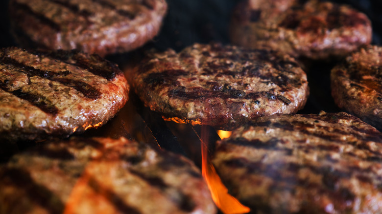 Burger patties cooking on a grill