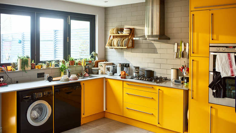 A retro kitchen interior with bright yellow cabinetry