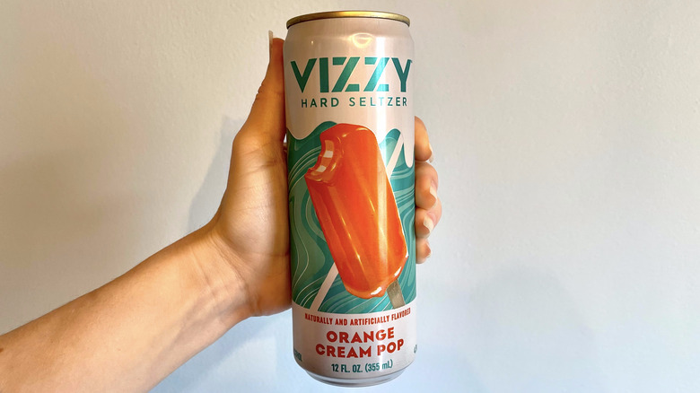 hand holding can of Vizzy