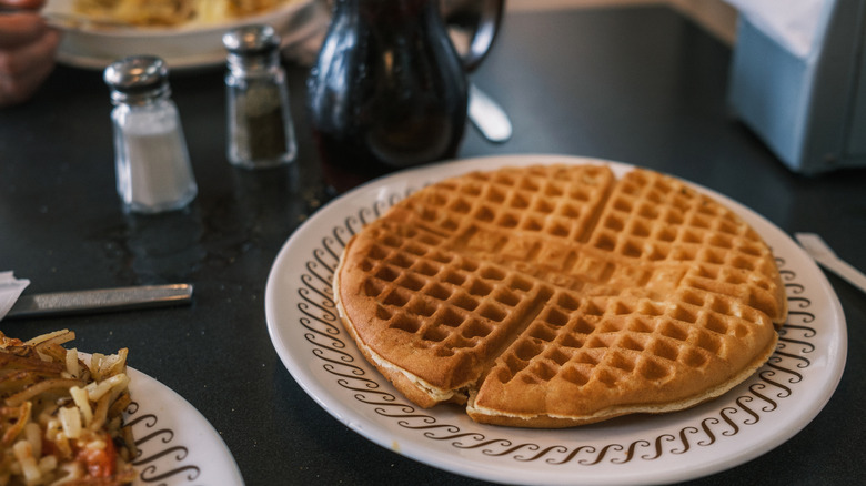 A Waffle House waffle on a plate in a booth