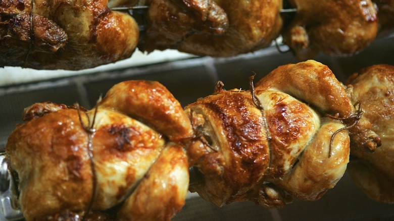 Rotisserie chickens being cooked