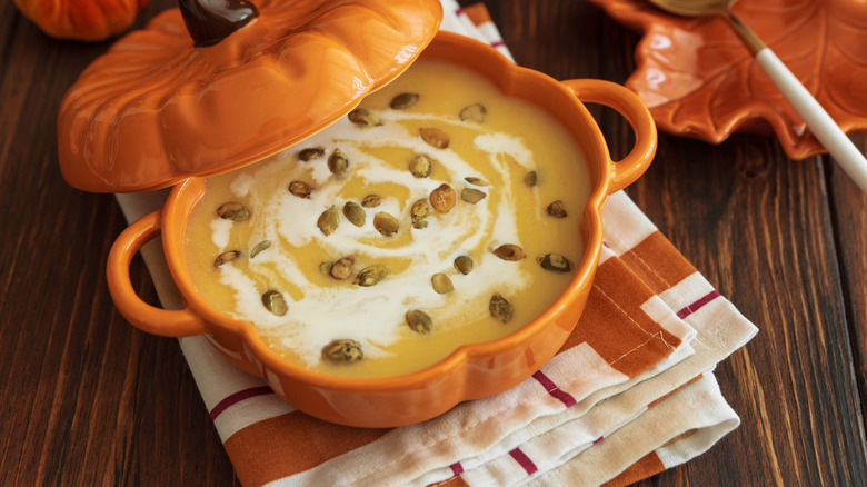 Pumpkin-shaped bowl filled with soup