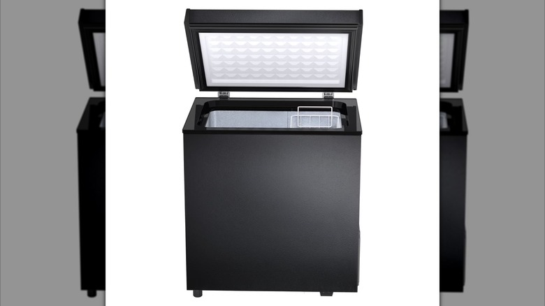 A black chest freezer opened to reveal sorting basket inside