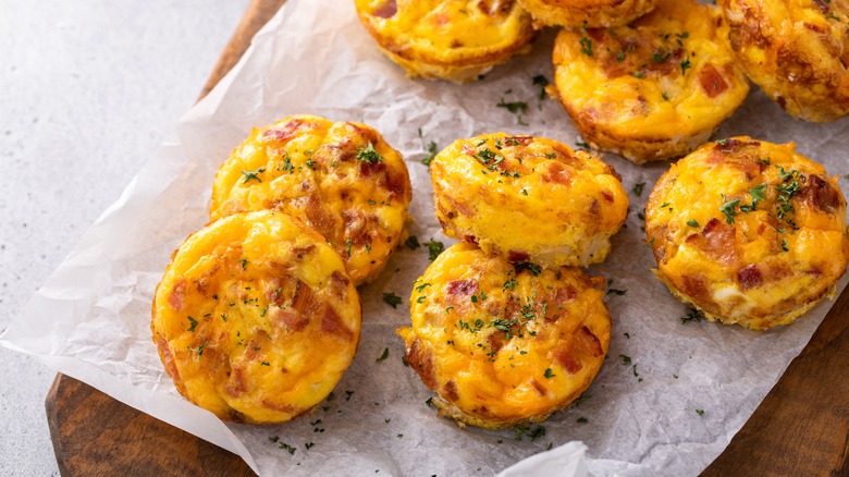 Bacon and cheddar egg bites on cutting board