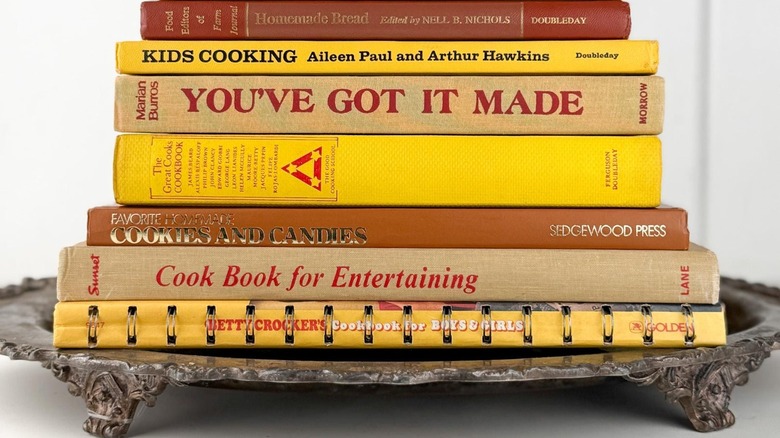 stack of vintage books on a vintage tray