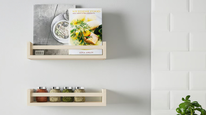 narrow shelves with spices and cookbooks