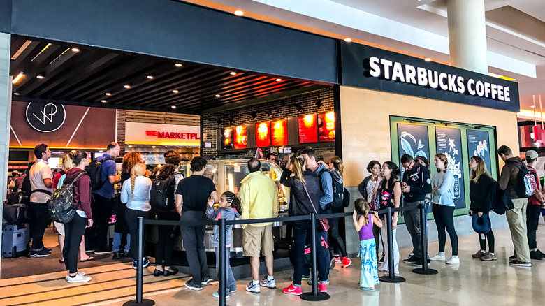 Customers waiting in line at a Starbucks cafe