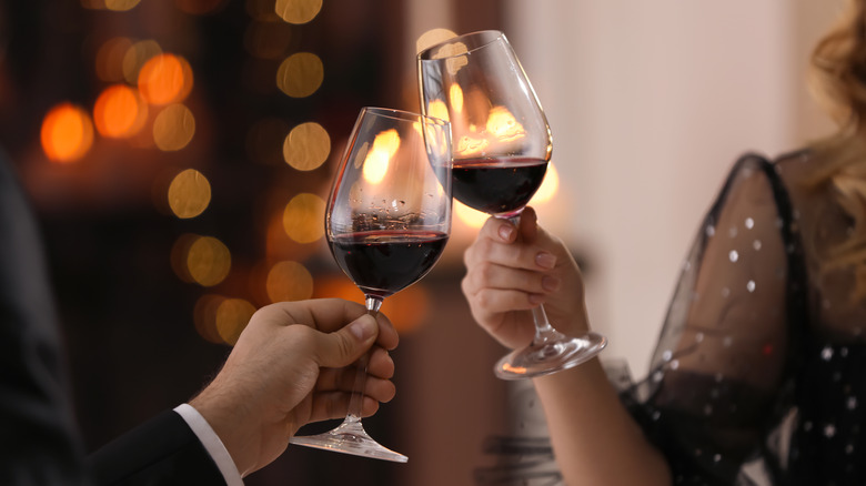 Couple clinking wine glasses