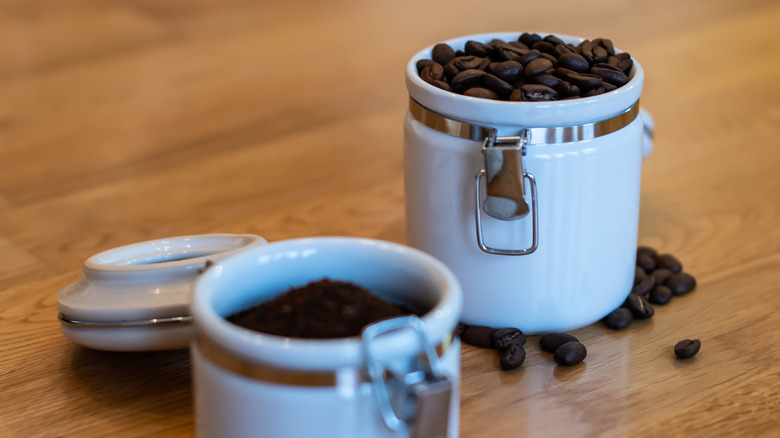 coffee in light canisters on wooden table