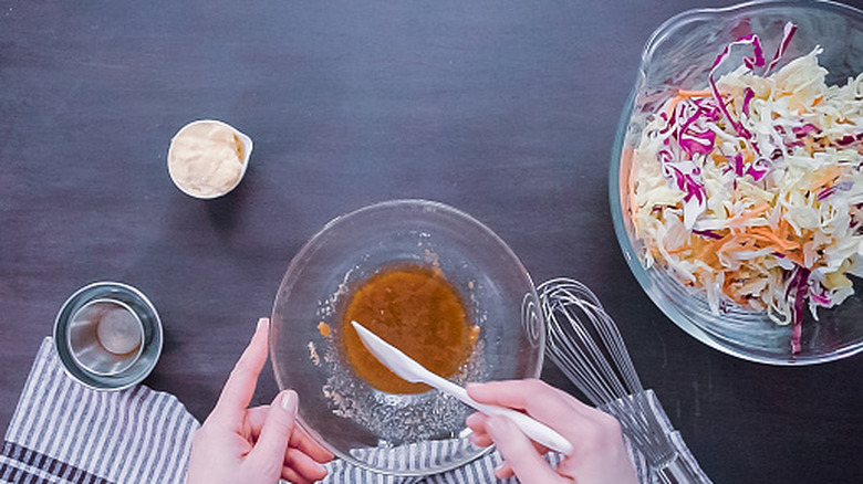 person using small bowl to mix ingredients