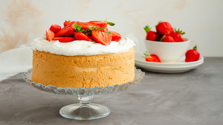 angel food cake, topped with whipped cream and strawberries