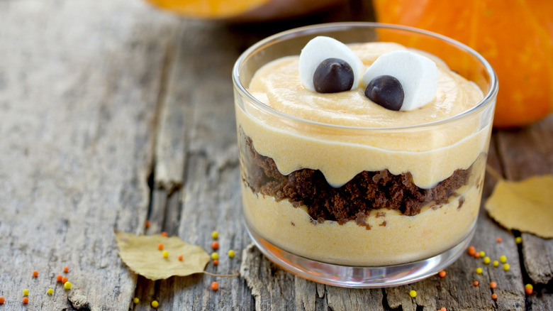 Pumpkin trifle on a wooden table with sprinkles