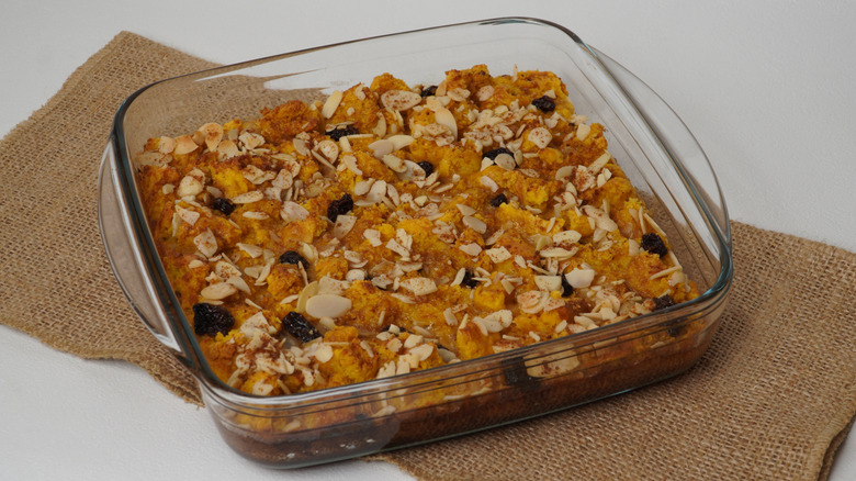 A baking dish full of pumpkin bread pudding on a table