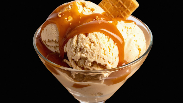 An ice cream sundae with caramel sauce in a glass jar