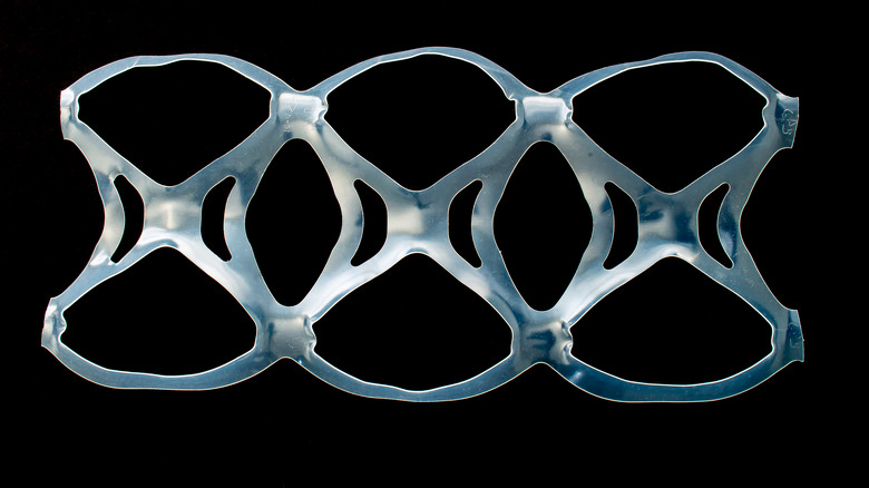 Plastic six-pack rings black background