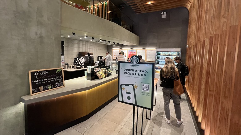Starbucks interior with queuing customers