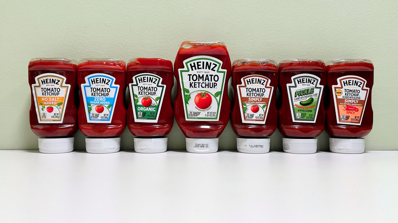 Varieties of Heinz ketchup lined up against a wall