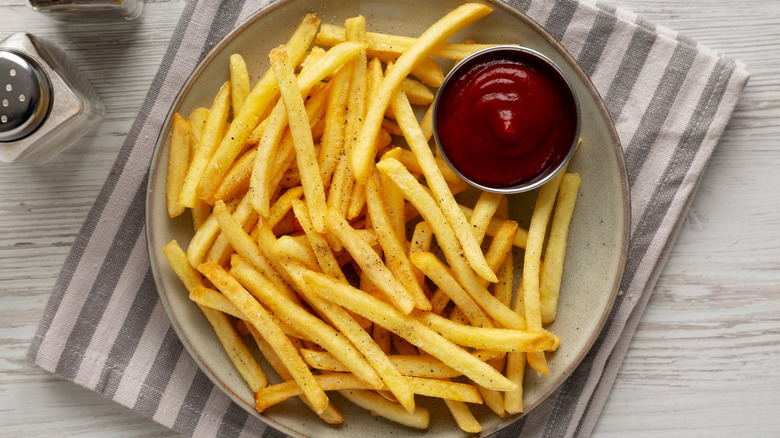 Plate of French fries with ketchup