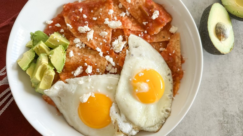 chilaquiles topped with eggs avocado