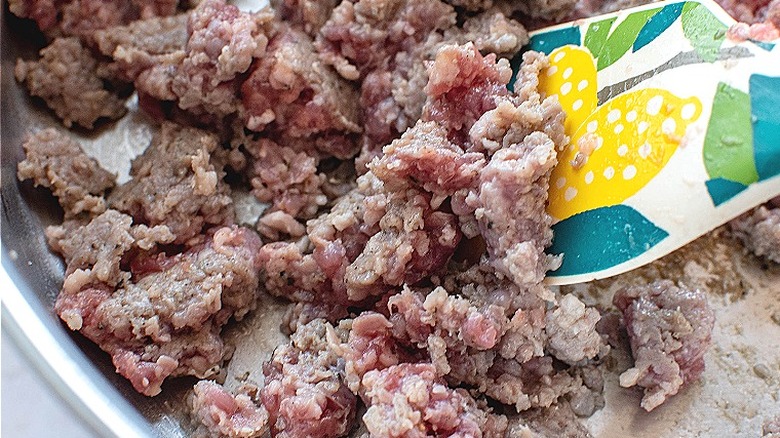 sausage browning in a skillet