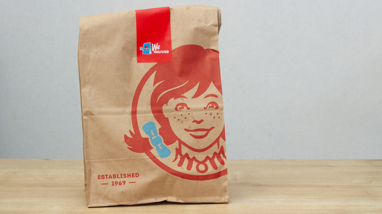 Wendy's to-go bag on wooden counter