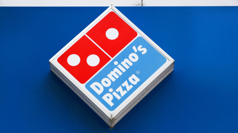 The Domino's logo is mounted on a wall